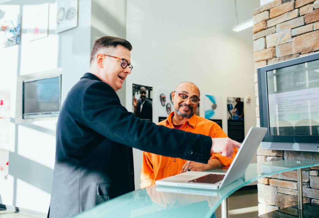 Sales rep showing client how his software can save him money