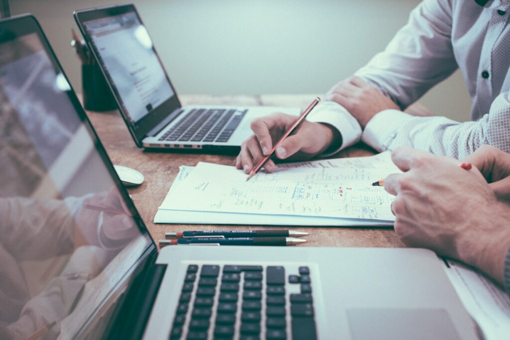 Business professional showing colleague how much money they will save with LinkedIn Sales Navigator